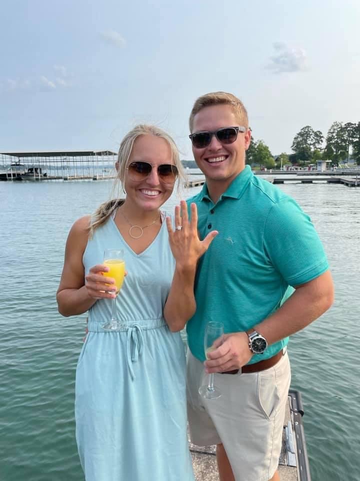 Couple getting engaged by the lake 