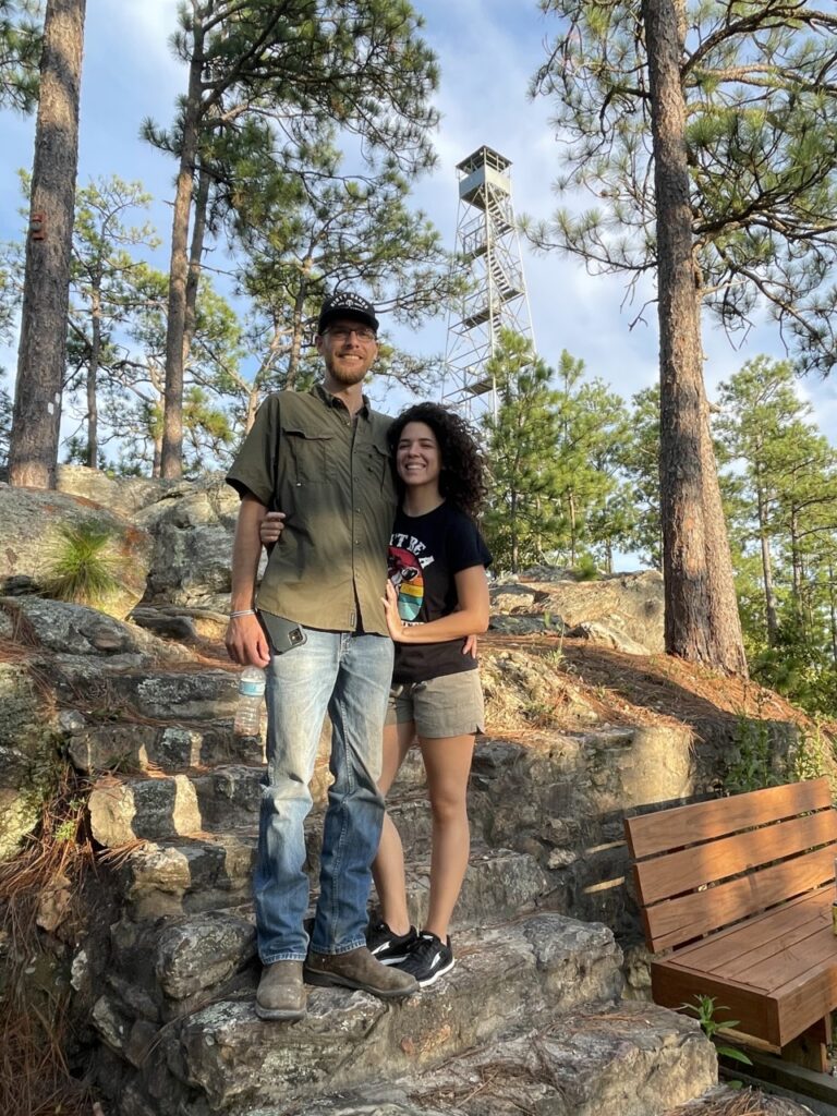 man and woman in front of smith mountain fire tower 