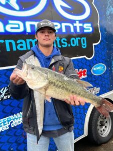 man holding fish at ogs fishing tournament