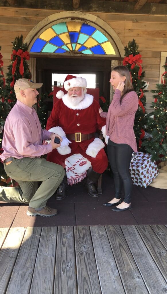 man proposing to girl by Santa 