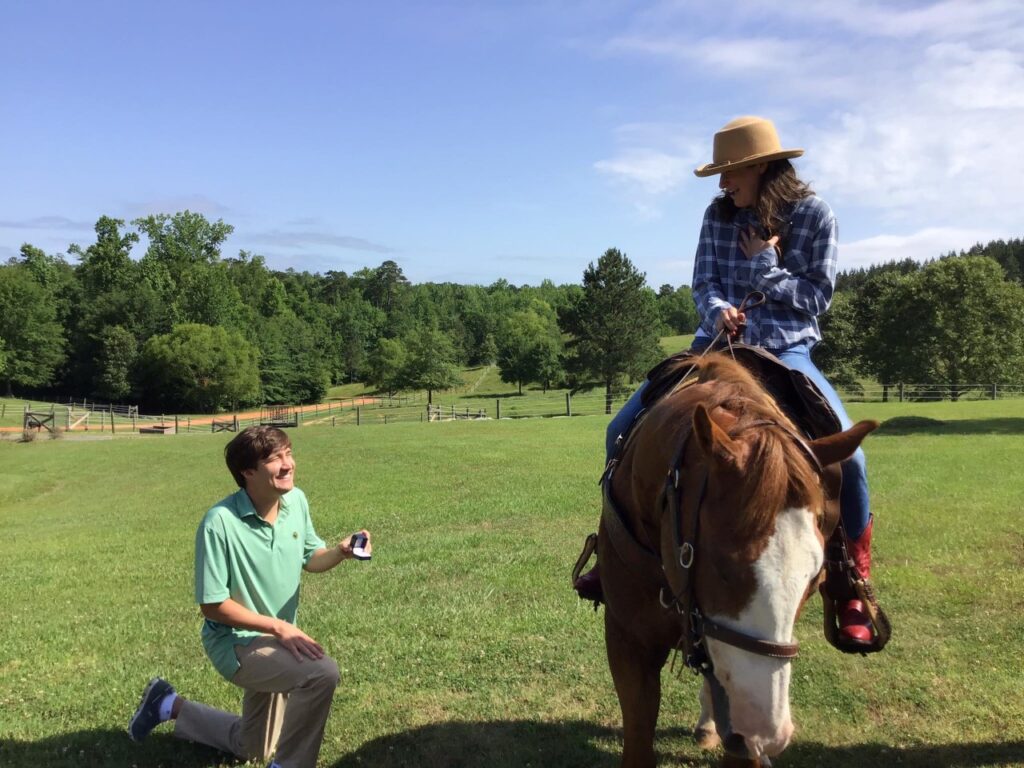 man proposing to woman on horse