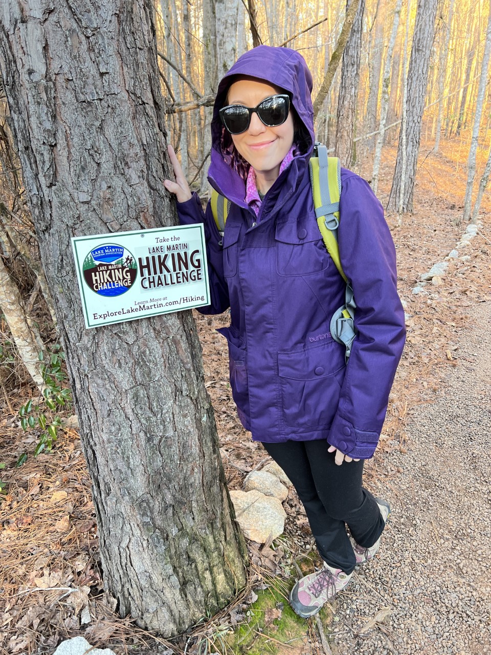 girl by hiking sign 