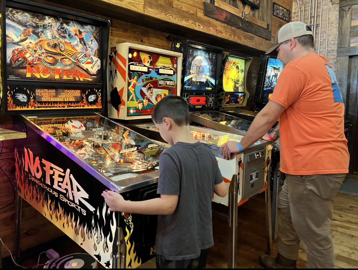 people playing pinball