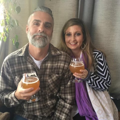 man and woman holding beer