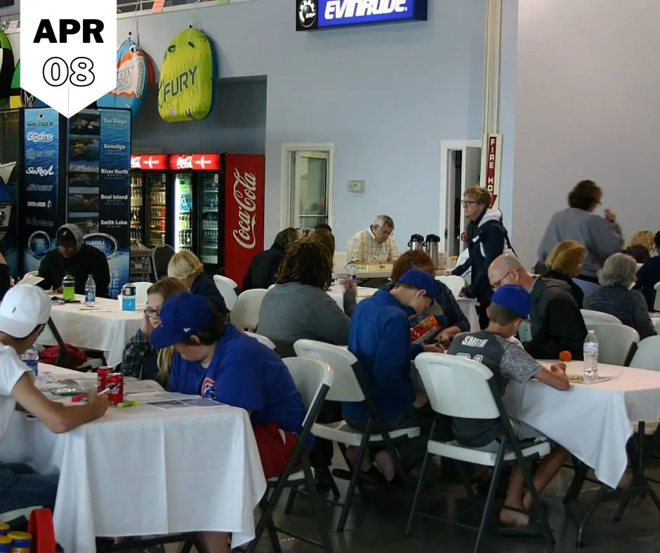 Group of men and women sitting inside a restaurant