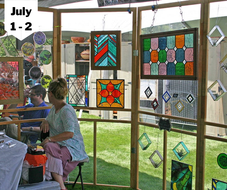 a woman sitting in the box with lots of art work