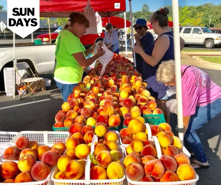 ladies buying peaches at the Pennington Park Farmers Market