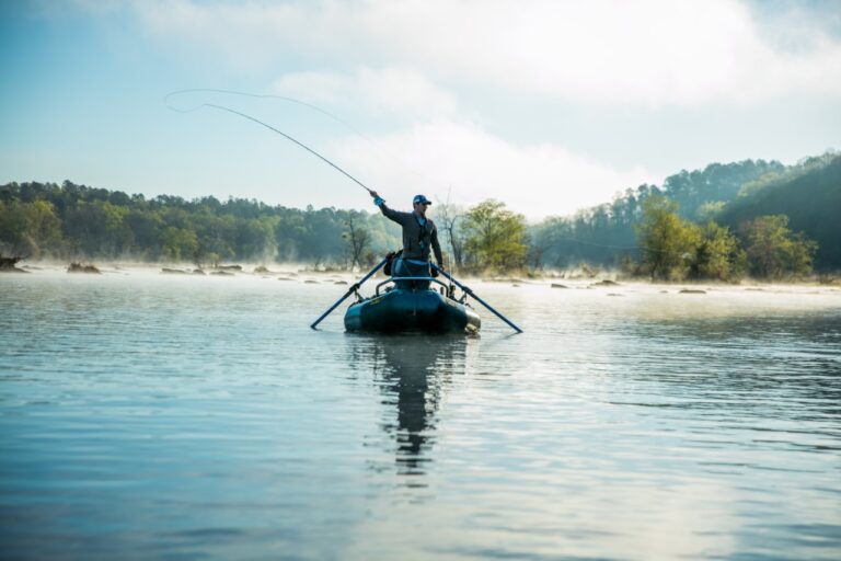 A fisherman casts a line from a boat