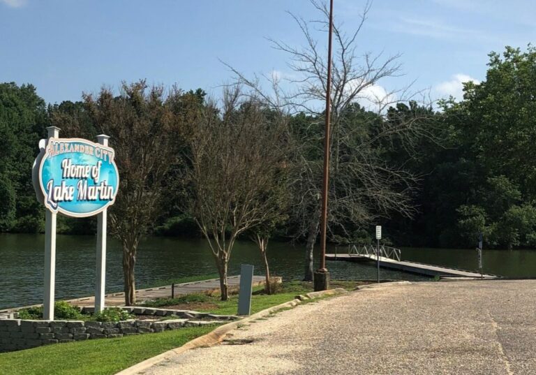 Sign reading: "Alexander City: Home of Lake Martin," near a dock