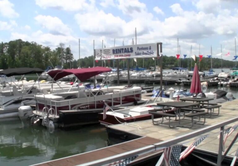 Boats docked in slips with sign reading "Rentals" above