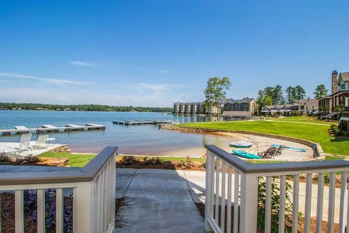 View from the porch of a rental property, looking out at blue sky and water