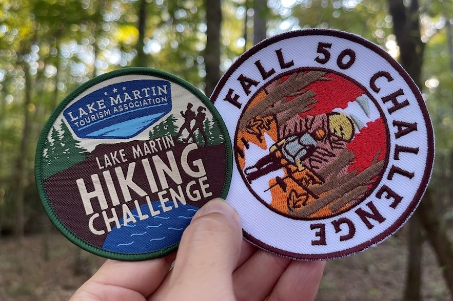 Two badges, one reading LAKE MARTIN HIKING CHALLENGE and the other FALL 50 CHALLENGE